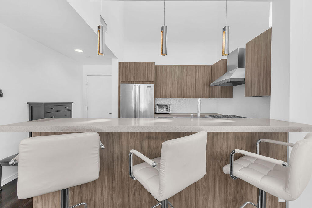 350 Goleta Way Palm Springs, CA 92264 - Photo 14 of 60 a kitchen with stainless steel appliances a sink and a refrigerator