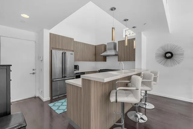 a kitchen with stainless steel appliances a stove a sink and a stove