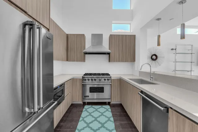 a kitchen with stainless steel appliances a sink and a counter space