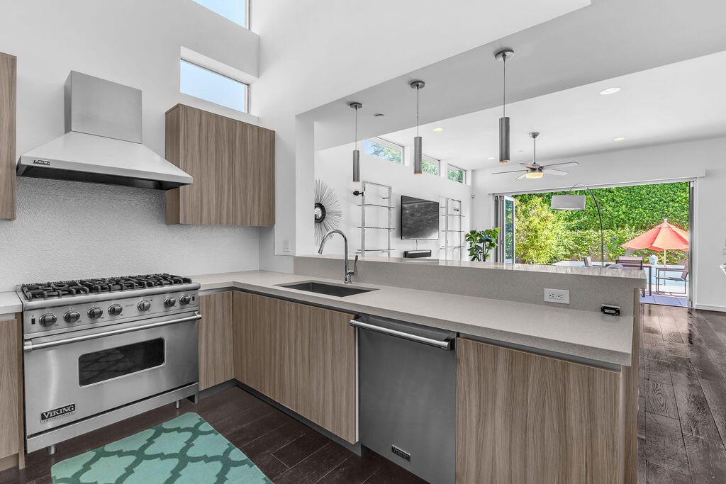 350 Goleta Way Palm Springs, CA 92264 - Photo 17 of 60 a kitchen with stainless steel appliances a stove a sink and a stove
