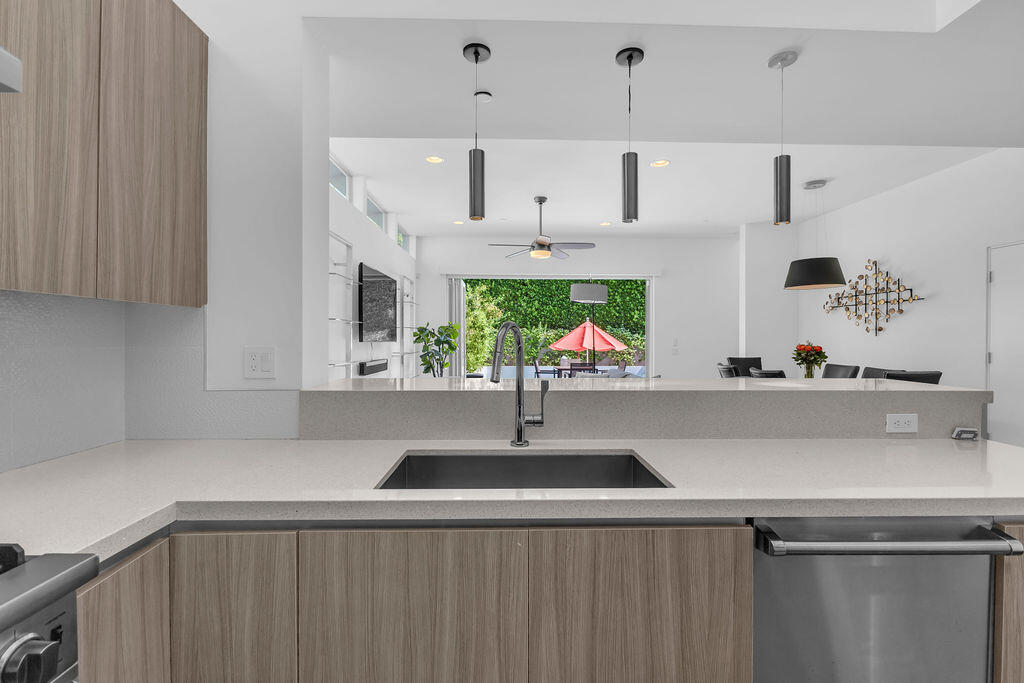 350 Goleta Way Palm Springs, CA 92264 - Photo 18 of 60 a kitchen with stainless steel appliances a sink and a counter space