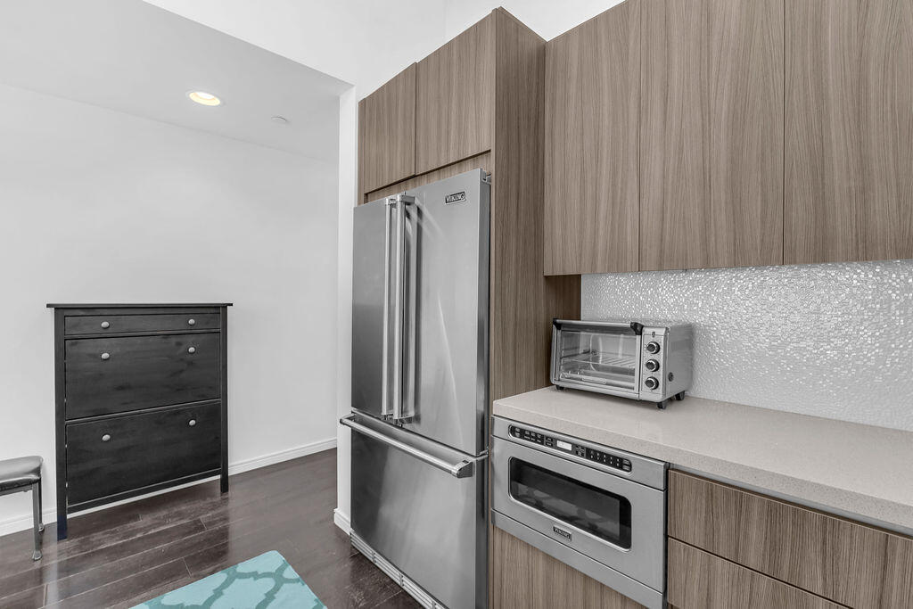 350 Goleta Way Palm Springs, CA 92264 - Photo 19 of 60 a kitchen with a refrigerator and cabinets