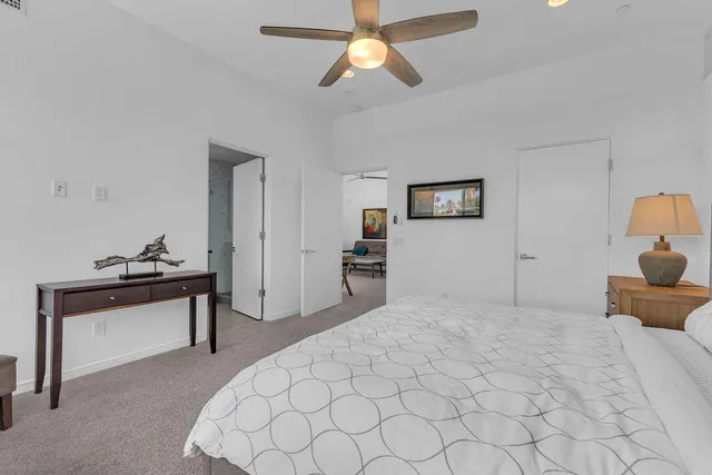 a bathroom with a toilet sink vanity and mirror