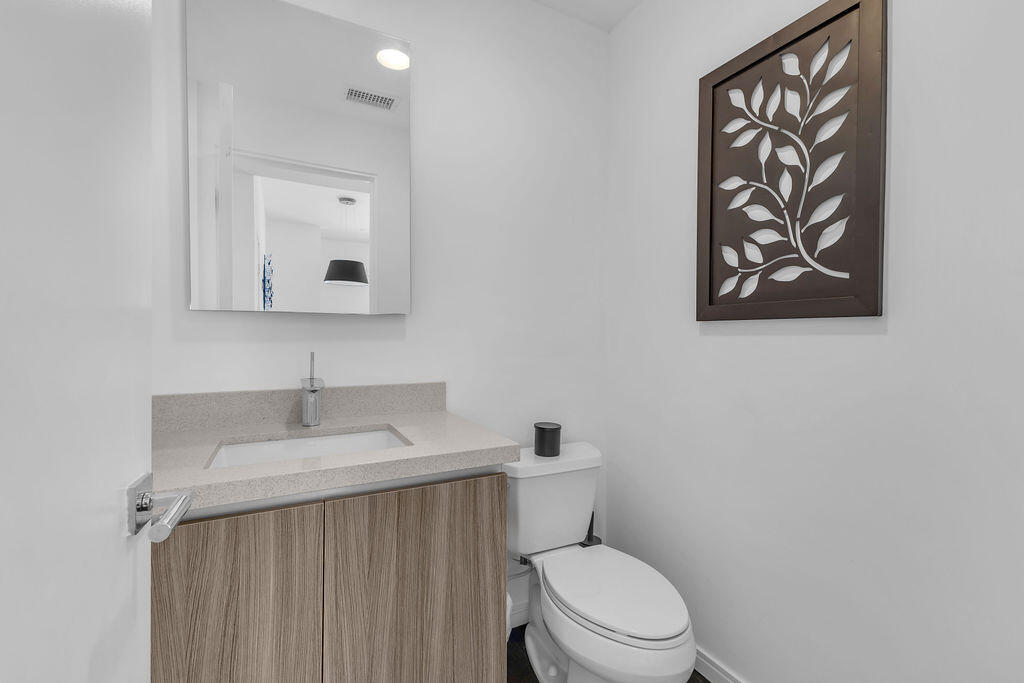 350 Goleta Way Palm Springs, CA 92264 - Photo 33 of 60 a bathroom with a toilet sink vanity and mirror