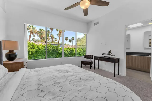 a bedroom with a bed and a television