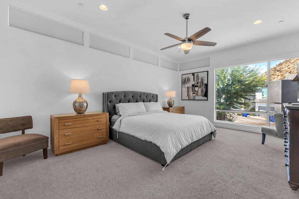 350 Goleta Way Palm Springs, CA 92264 - Photo 35 of 60 a bedroom with a bed and a chandelier