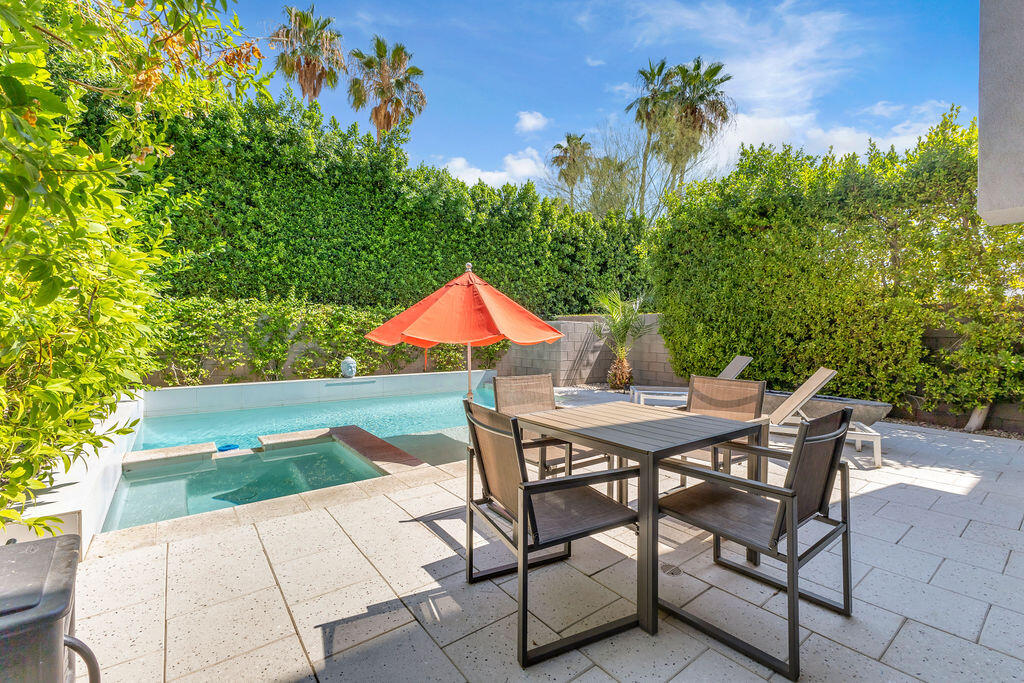 350 Goleta Way Palm Springs, CA 92264 - Photo 40 of 60 a view of backyard with table and chairs and potted plants