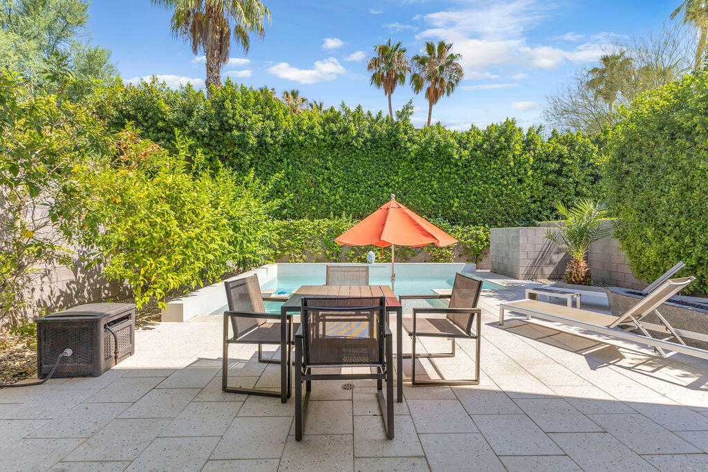 350 Goleta Way Palm Springs, CA 92264 - Photo 41 of 60 a view of a patio with table and chairs and potted plants