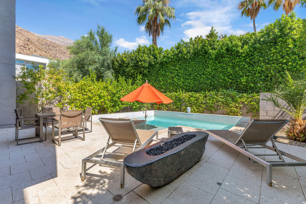 350 Goleta Way Palm Springs, CA 92264 - Photo 42 of 60 a view of a patio with table and chairs and potted plants