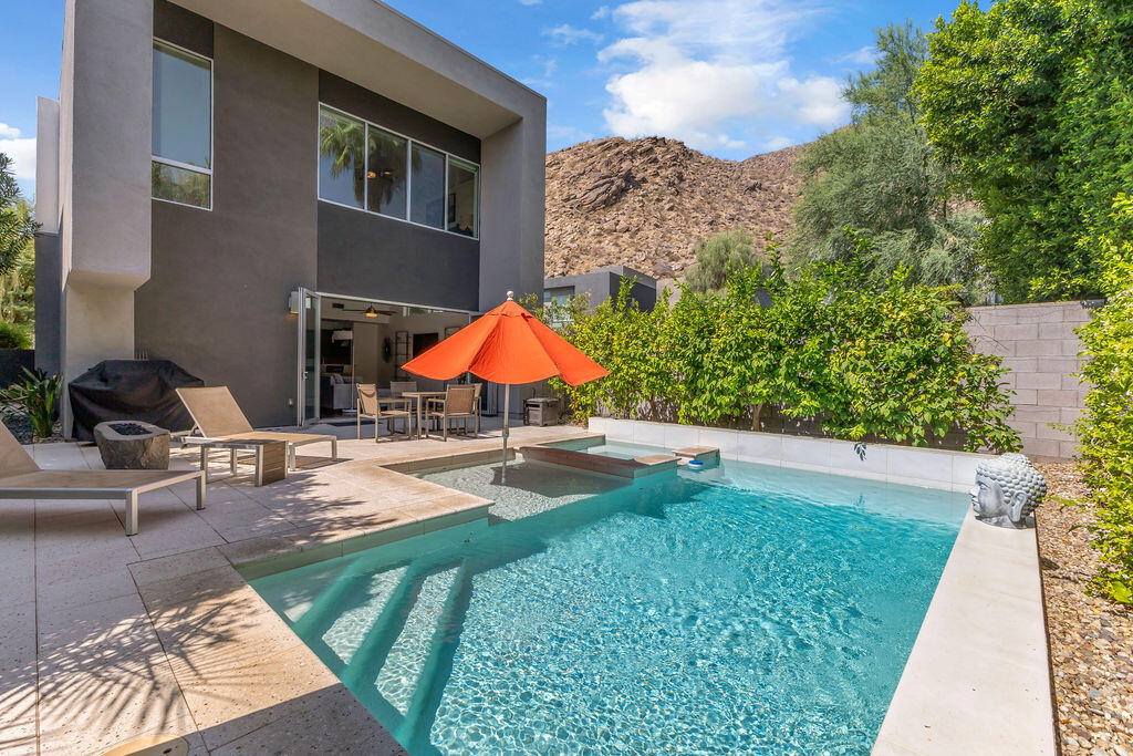 350 Goleta Way Palm Springs, CA 92264 - Photo 44 of 60 a view of pool with lawn chairs under an umbrella