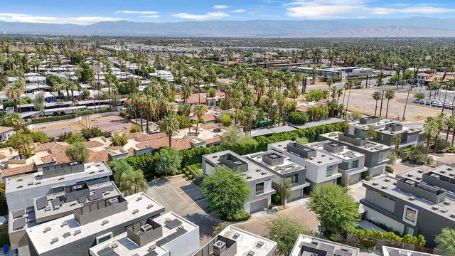 an aerial view of a house with a yard basket ball court and outdoor seating