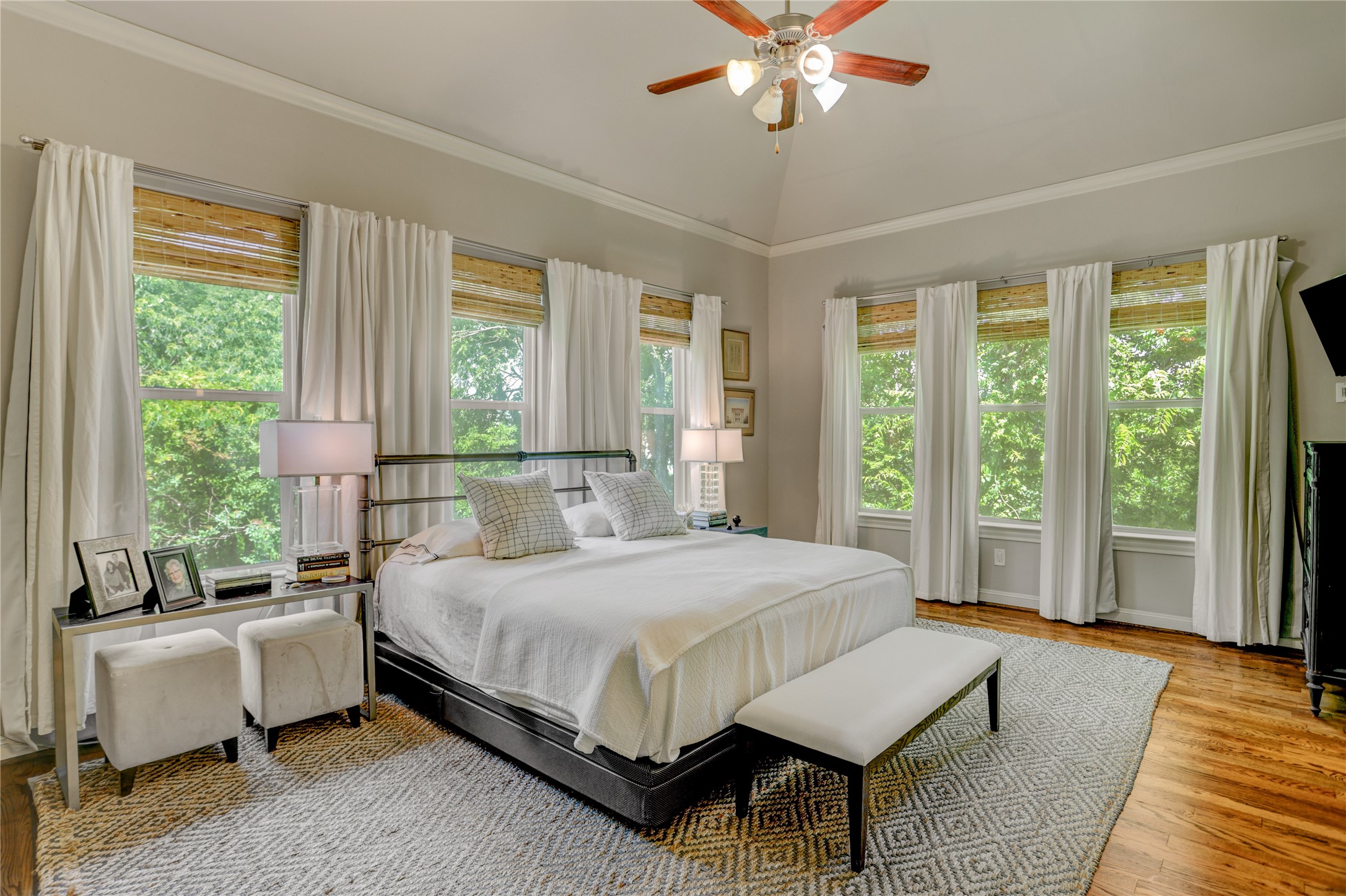 4124 Bonner View Lane Houston, TX 77007 - Photo 1 of 31 Relax in the spacious 14x19 SF primary bedroom suite, where abundant windows invite natural light while offering serene privacy, thanks to its prime spot overlooking the lush, tree-lined White Oak Bayou.