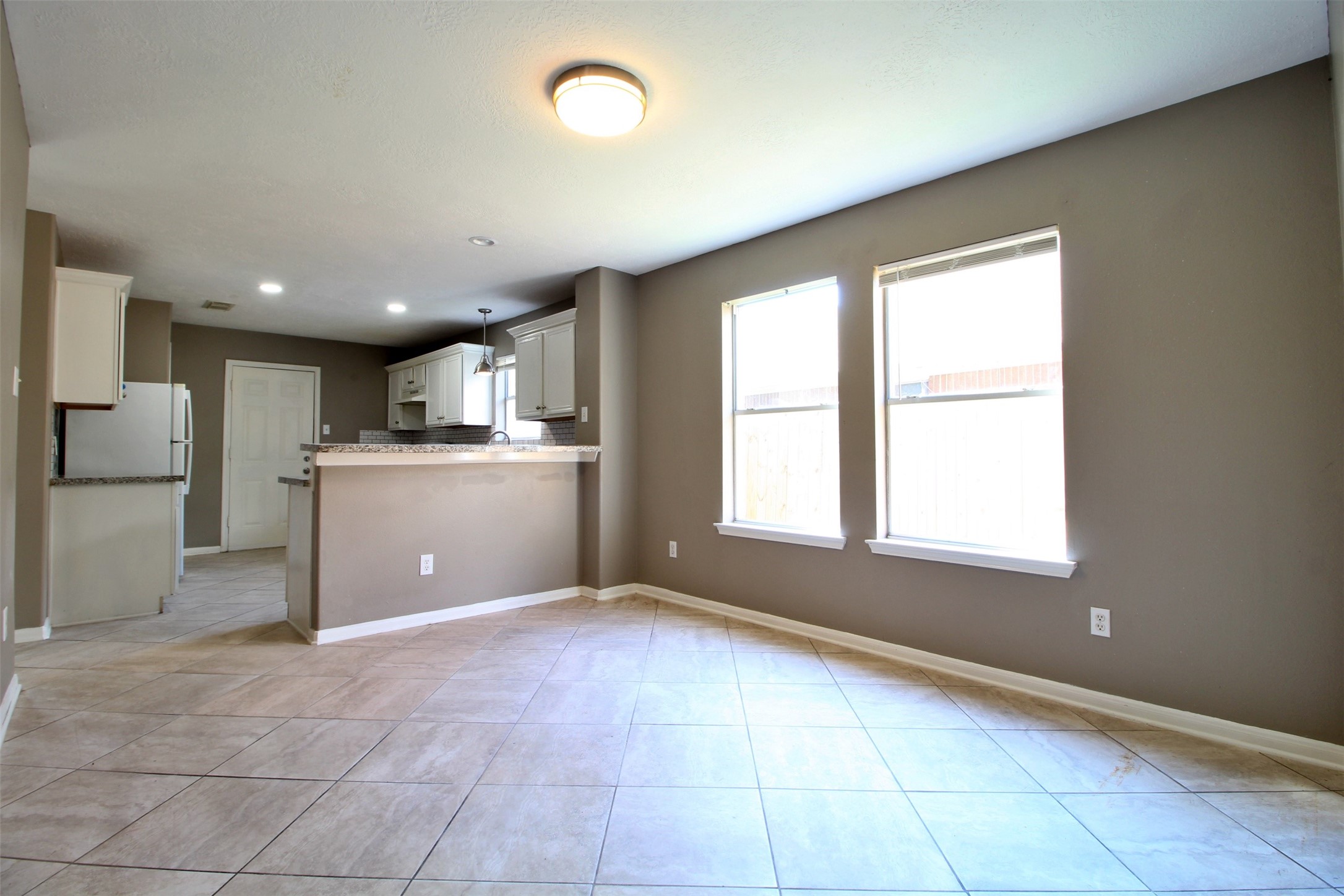 6803 Highwind Bend Lane Katy, TX 77449 - Photo 4 of 10 a open kitchen with kitchen island a stove a refrigerator and a sink