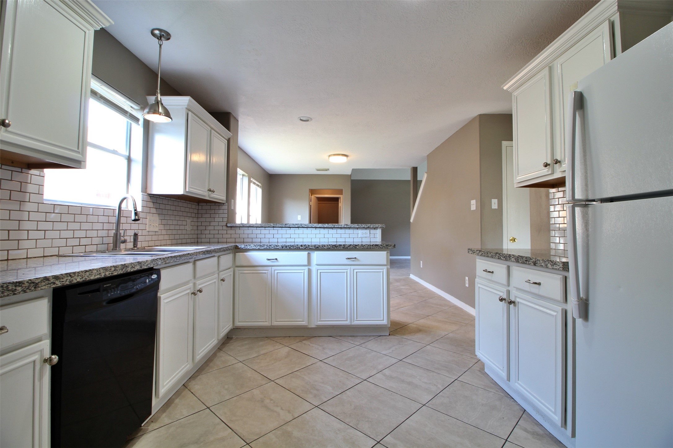 6803 Highwind Bend Lane Katy, TX 77449 - Photo 5 of 10 a kitchen with white cabinets and white appliances