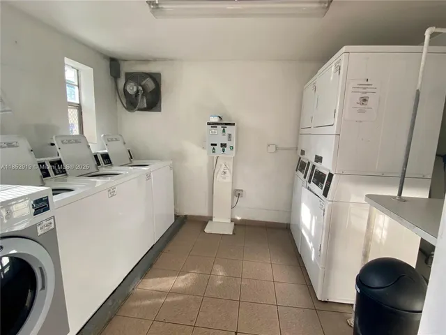 a view of a storage and utility room with a washer dryer and a large window