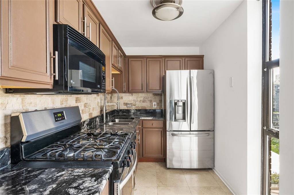 620 Peachtree Street Northeast, Unit 1716 Atlanta, GA 30308 - Photo 15 of 37 a kitchen with stainless steel appliances granite countertop a refrigerator stove and sink