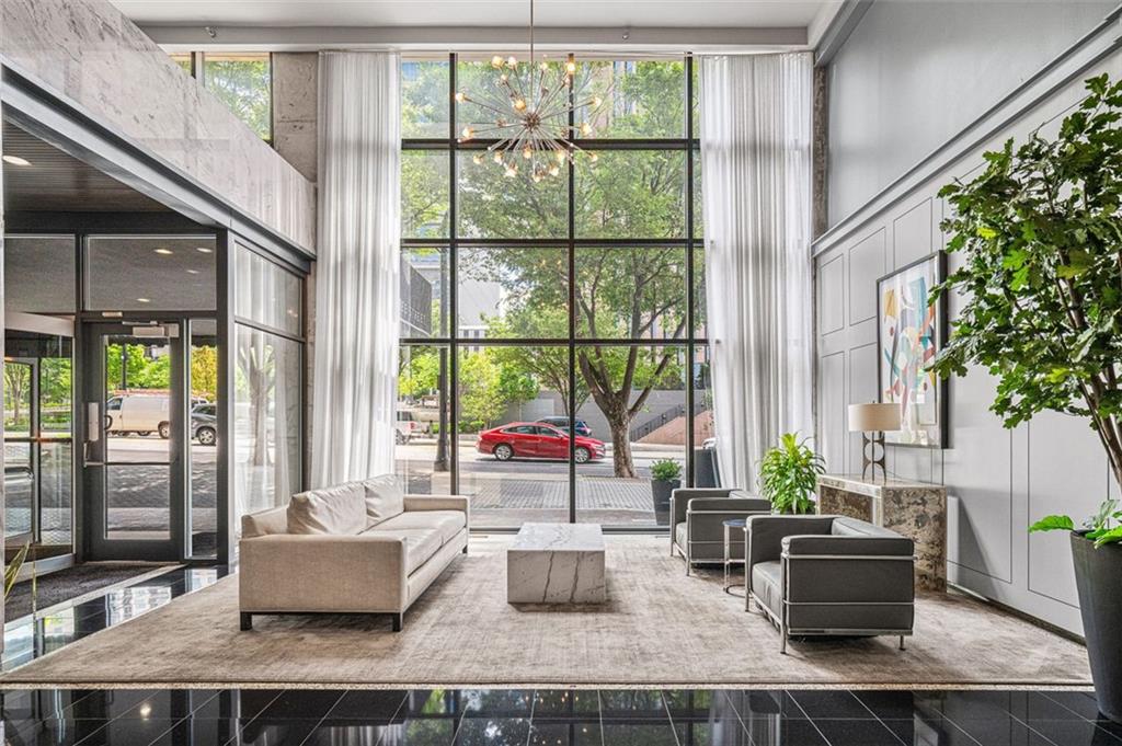620 Peachtree Street Northeast, Unit 1716 Atlanta, GA 30308 - Photo 20 of 37 a living room with furniture and large windows