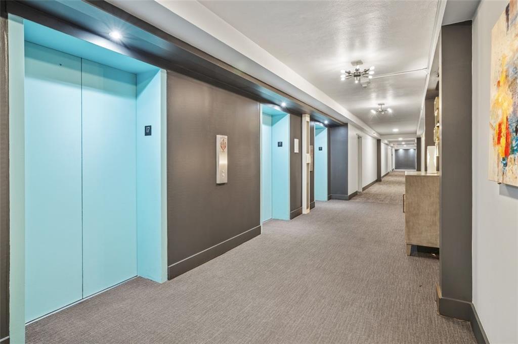 620 Peachtree Street Northeast, Unit 1716 Atlanta, GA 30308 - Photo 2 of 37 a view of a hallway with chandelier and glass door