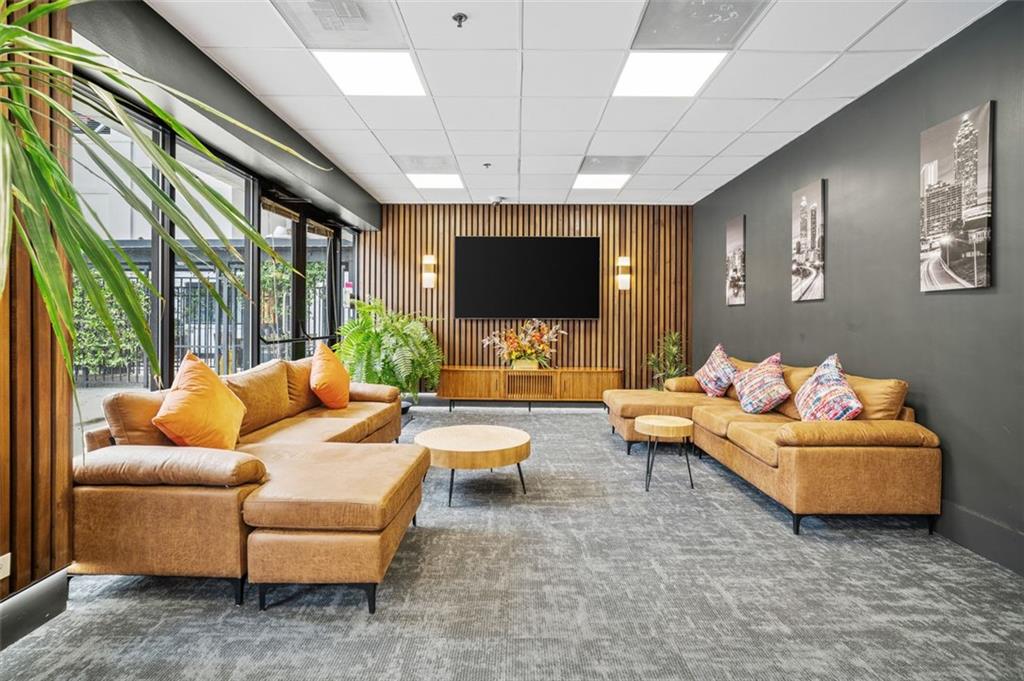 620 Peachtree Street Northeast, Unit 1716 Atlanta, GA 30308 - Photo 22 of 37 a living room with furniture and a flat screen tv