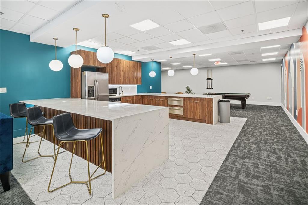 620 Peachtree Street Northeast, Unit 1716 Atlanta, GA 30308 - Photo 24 of 37 a large kitchen with a table and chairs