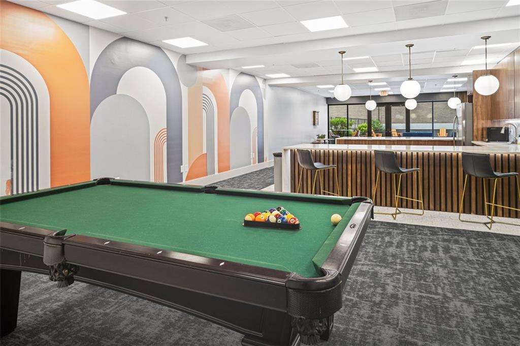 620 Peachtree Street Northeast, Unit 1716 Atlanta, GA 30308 - Photo 25 of 37 a room with lots of white furniture and a swimming pool