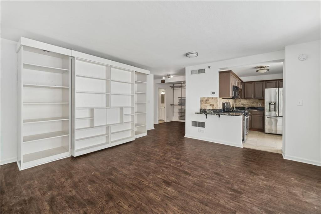 620 Peachtree Street Northeast, Unit 1716 Atlanta, GA 30308 - Photo 5 of 37 a view of a kitchen with refrigerator and white cabinets