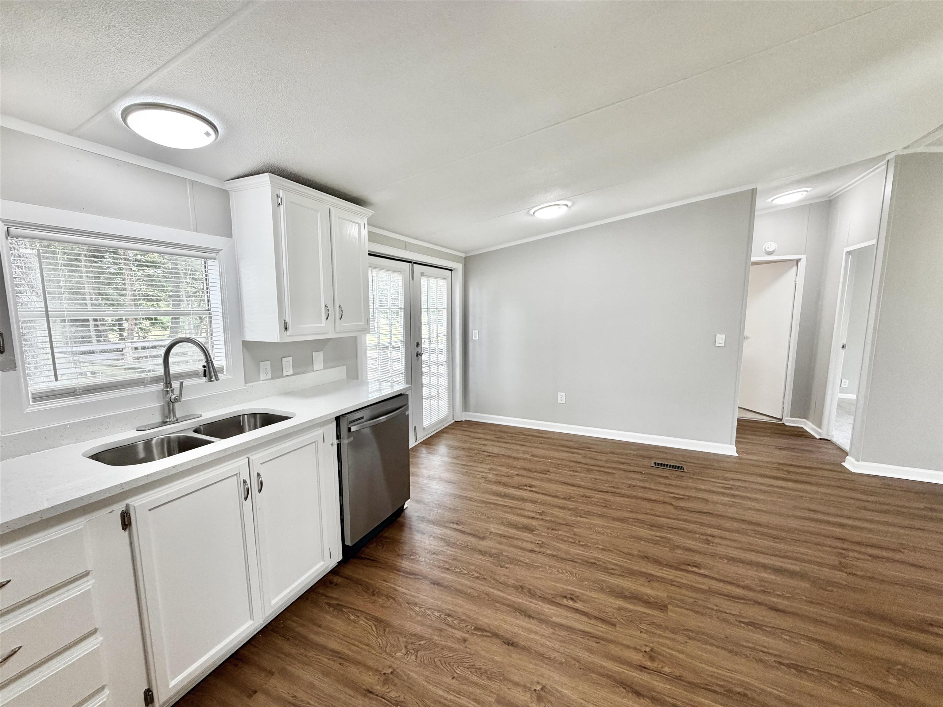 1655 Fayne Road Brighton, TN 38011 - Photo 5 of 28 Kitchen featuring white cabinetry, a dual-basin stainless steel sink with a gooseneck faucet, a stainless steel dishwasher, and light-toned countertops