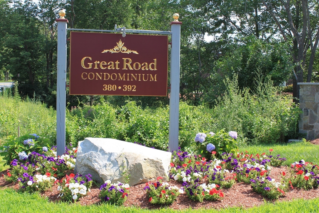 a sign that is in front of flowers