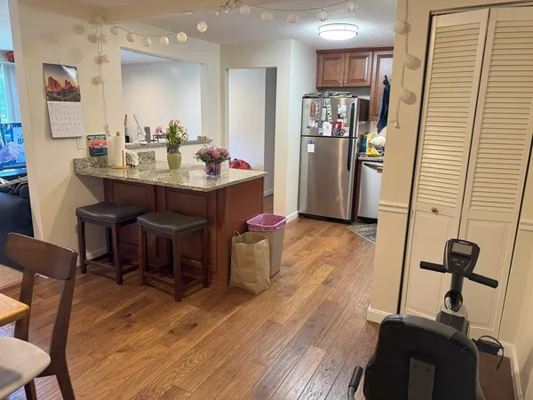 a view of a dining room with furniture and wooden floor
