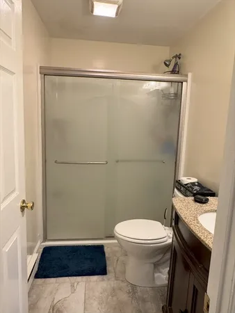 a bathroom with a toilet and a shower