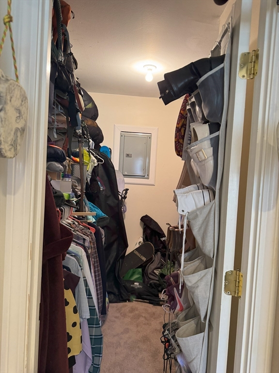 390 Great Road, Unit B19 Acton, MA 01720 - Photo 9 of 10 a view of walk in closet with clothes and shoes
