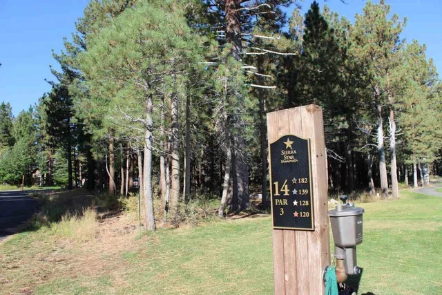 a view of white house with snow on the road
