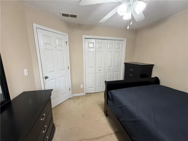 a bedroom with a bed and chandelier