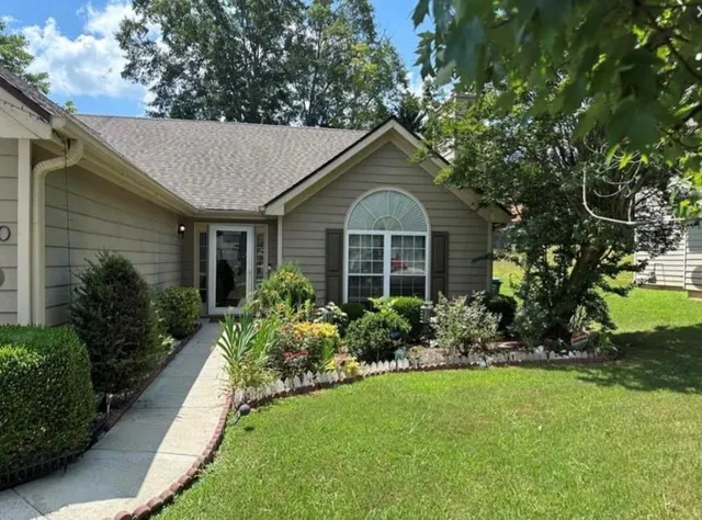 a front view of a house with a yard