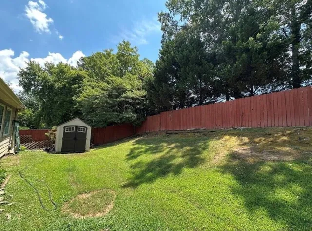 a front view of a house with a garden and yard