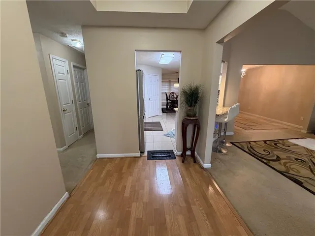 a view of a room with wooden floor