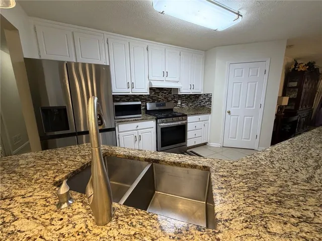a kitchen with refrigerator and window