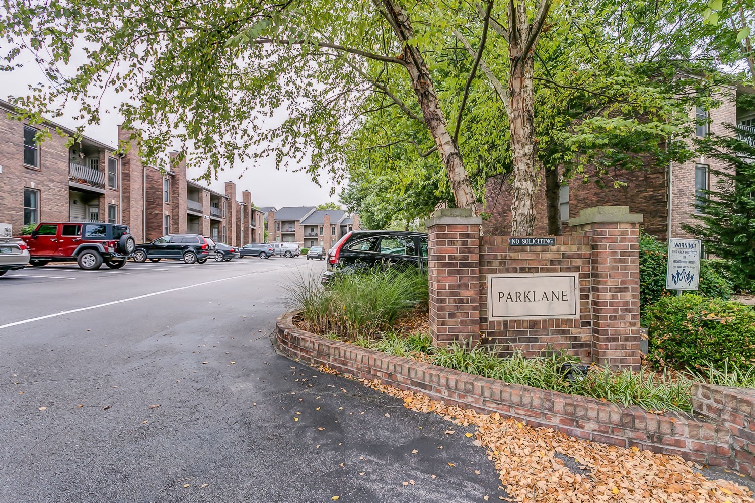 a view of a street with a cars parked in front of it