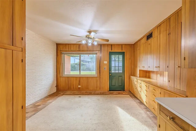 a kitchen with stainless steel appliances a refrigerator and a stove top oven