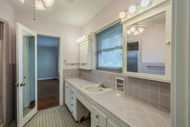 a view of n empty room with window and wooden floor