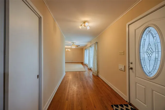 a view of a hallway with wooden floor
