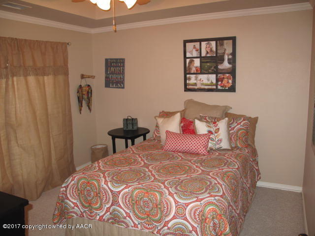 6606 Rally Road Amarillo, TX 79119 - Photo 12 of 20 a bedroom with a bed and a window