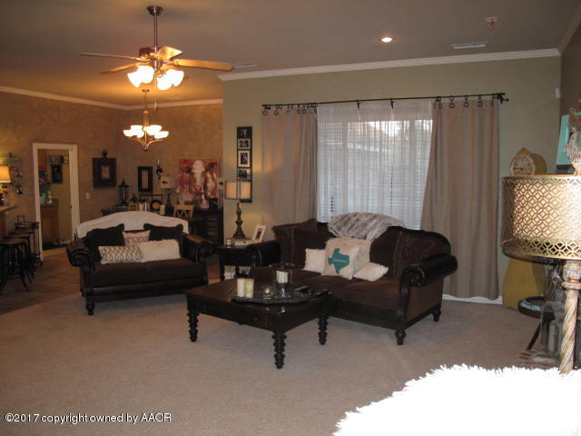6606 Rally Road Amarillo, TX 79119 - Photo 4 of 20 a living room with furniture and a chandelier