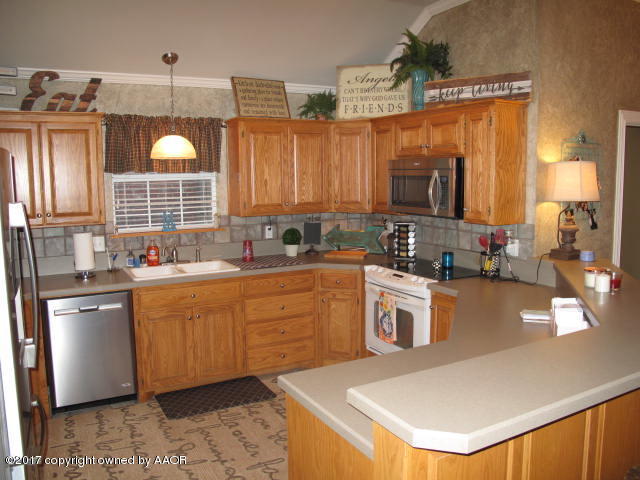6606 Rally Road Amarillo, TX 79119 - Photo 8 of 20 a kitchen with a refrigerator and a sink