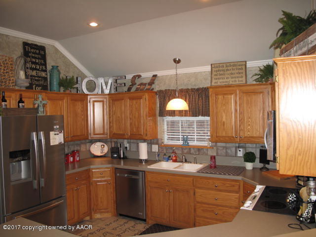 6606 Rally Road Amarillo, TX 79119 - Photo 9 of 20 a kitchen with stainless steel appliances granite countertop a sink and a refrigerator