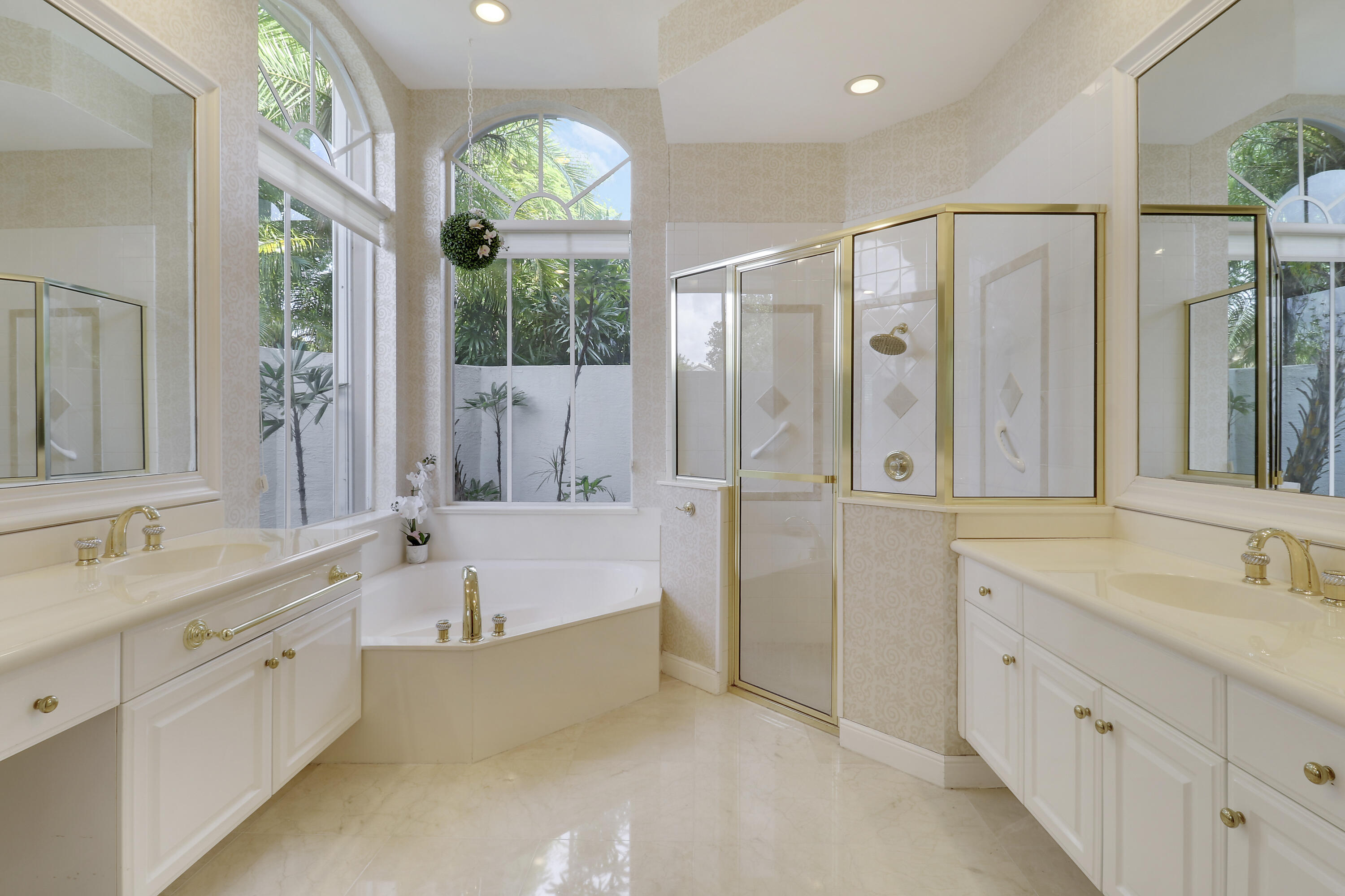 8216 Cypress Point Road West Palm Beach, FL 33412 - Photo 11 of 62 a bathroom with a tub a sink double vanity and a large mirror