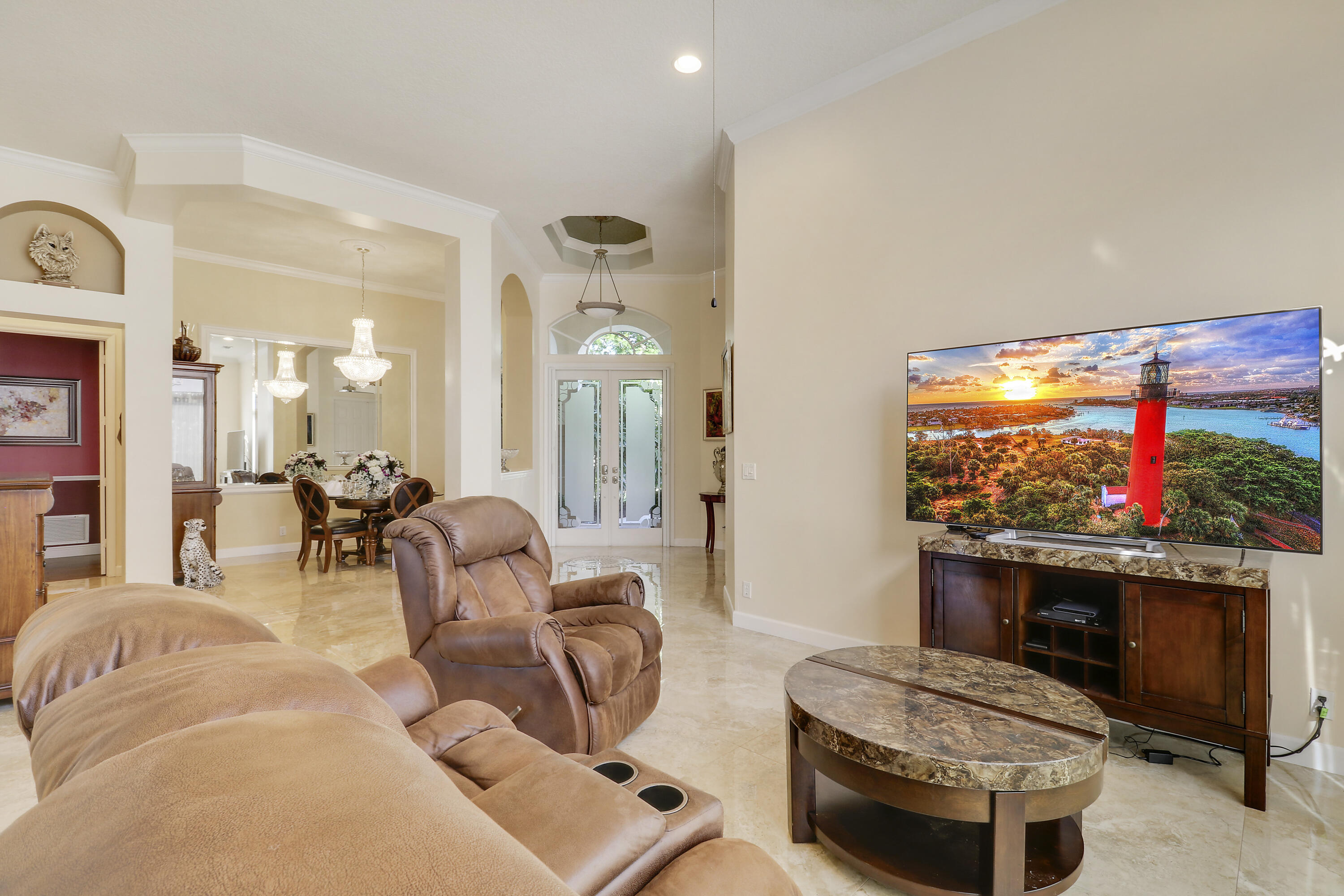 8216 Cypress Point Road West Palm Beach, FL 33412 - Photo 22 of 62 a living room with furniture a flat screen tv and a fireplace