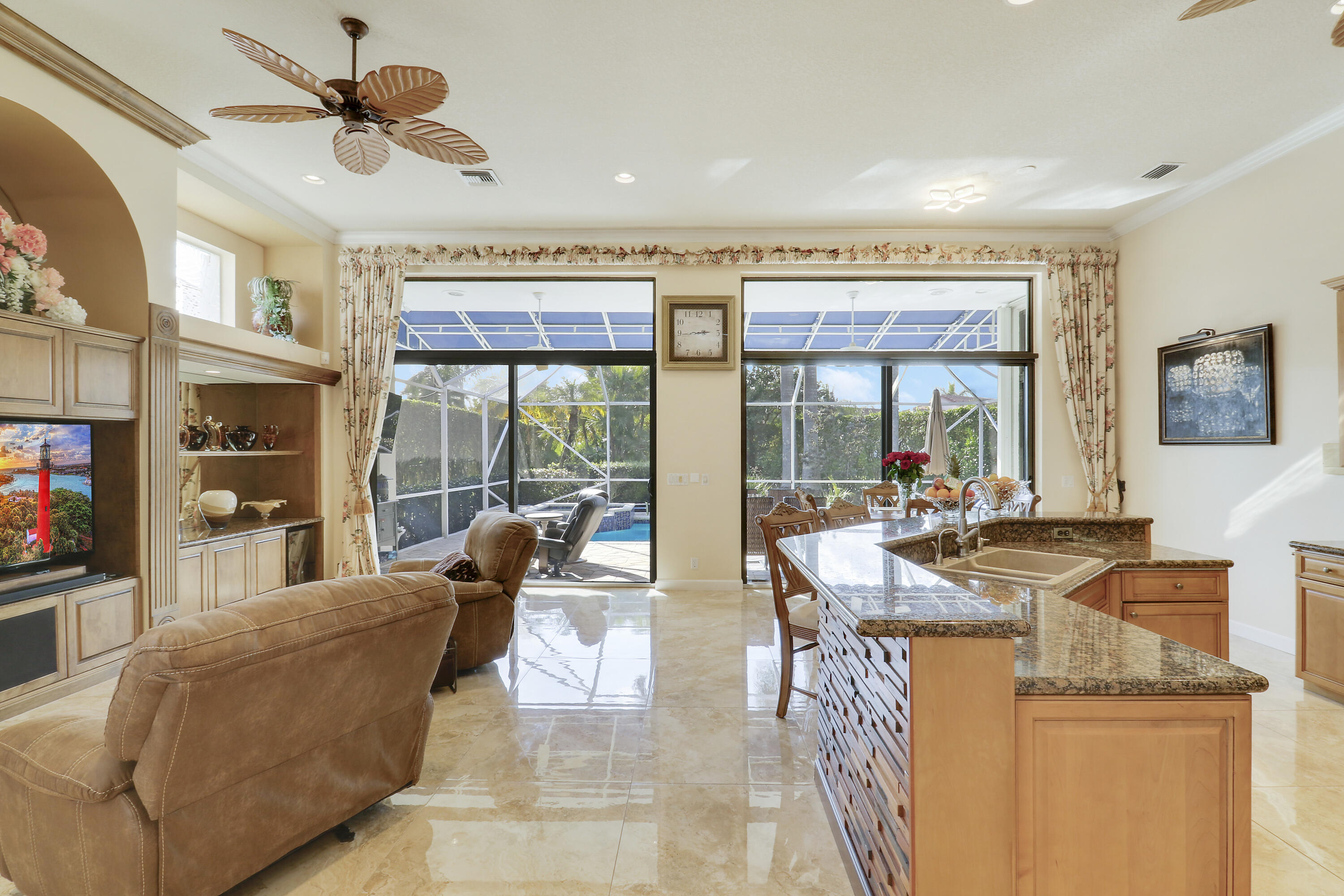 8216 Cypress Point Road West Palm Beach, FL 33412 - Photo 23 of 62 a living room with fireplace furniture and a floor to ceiling window