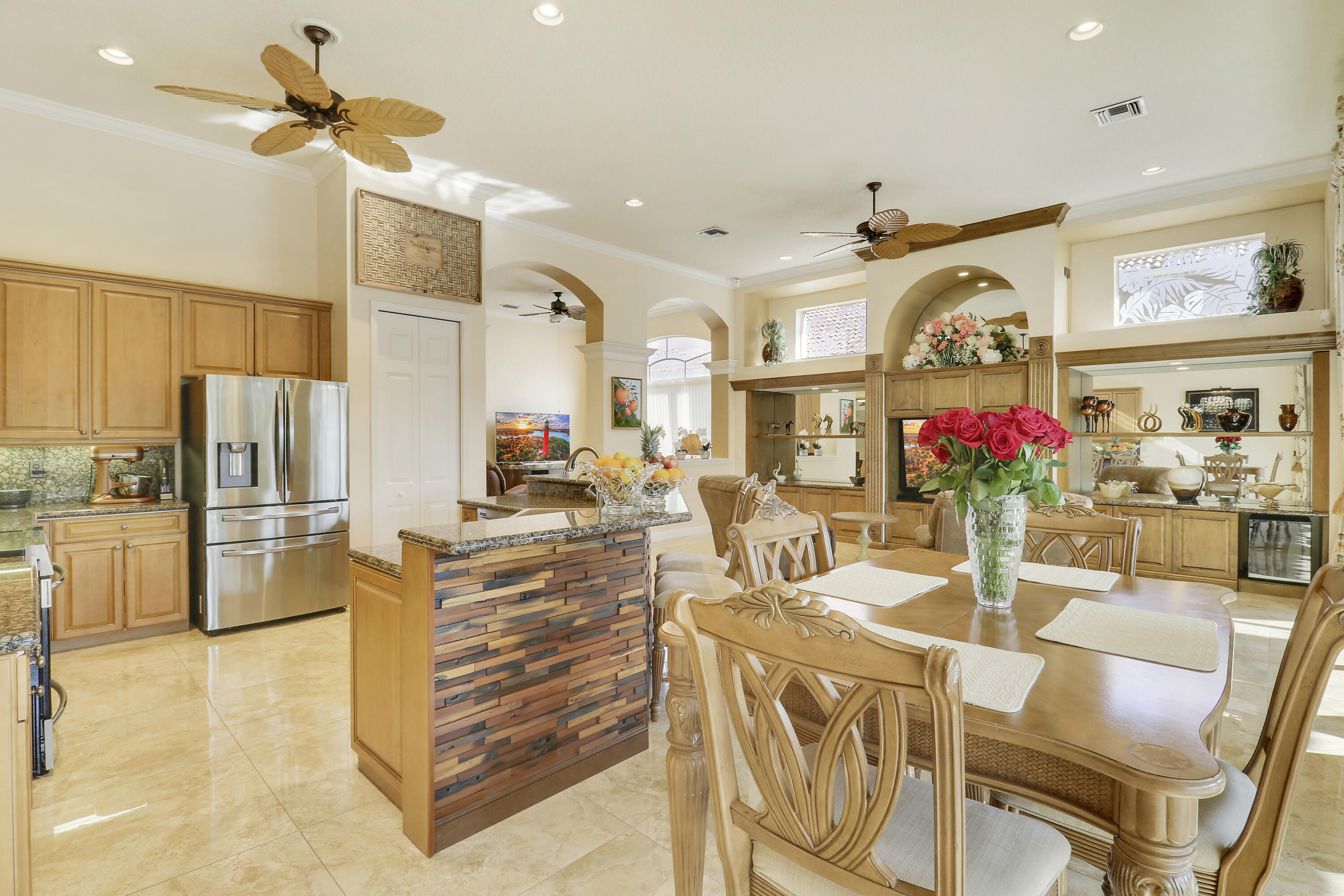 8216 Cypress Point Road West Palm Beach, FL 33412 - Photo 32 of 62 a view of a dining room with furniture a kitchen and chandelier