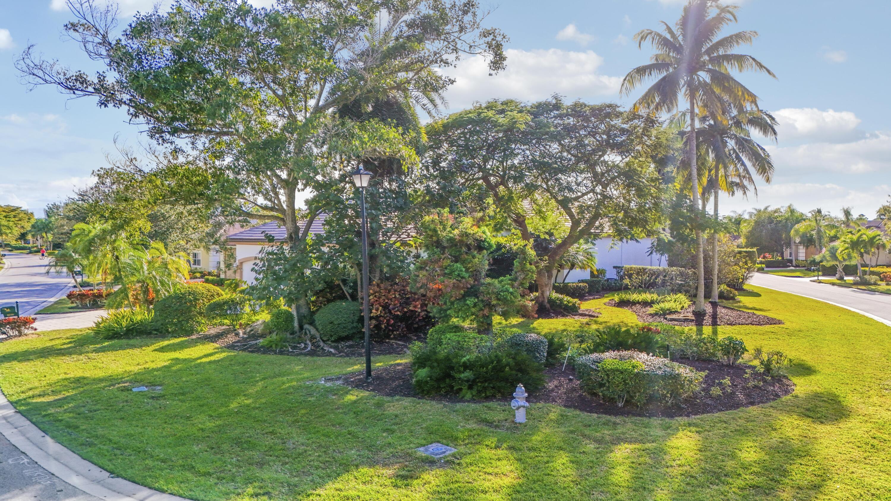 8216 Cypress Point Road West Palm Beach, FL 33412 - Photo 41 of 62 a view of a swimming pool with a garden